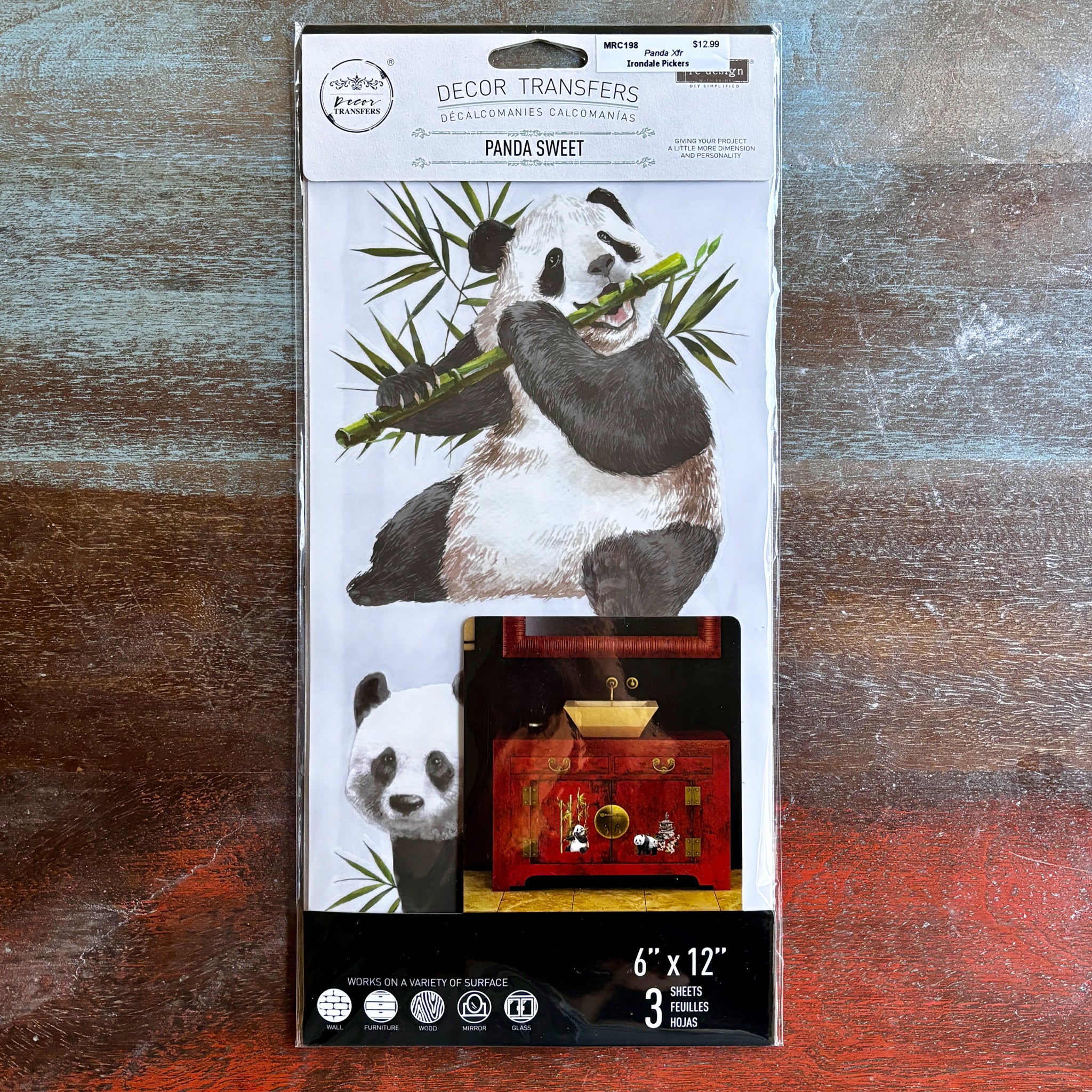 A package of ReDesign with Prima's Panda Sweet small transfer is against a dark wood background.