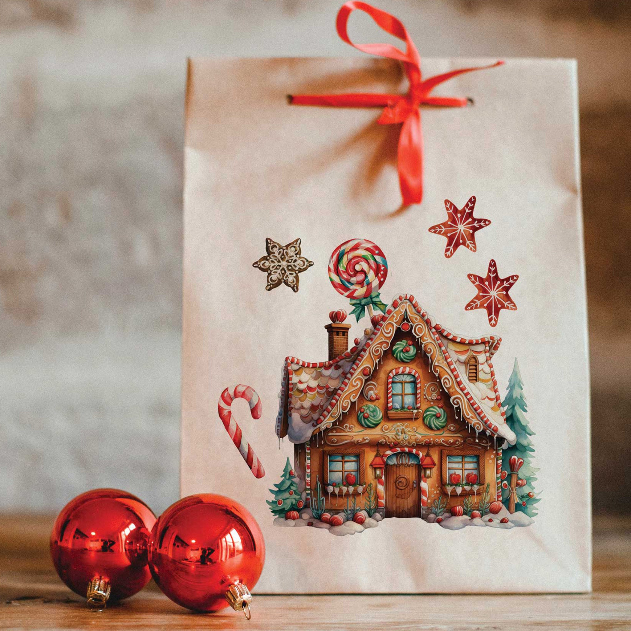 A paper gift bag features a gingerbread house from ReDesign with Prima's Winter Wonderland Wonders small rub on transfer on it.