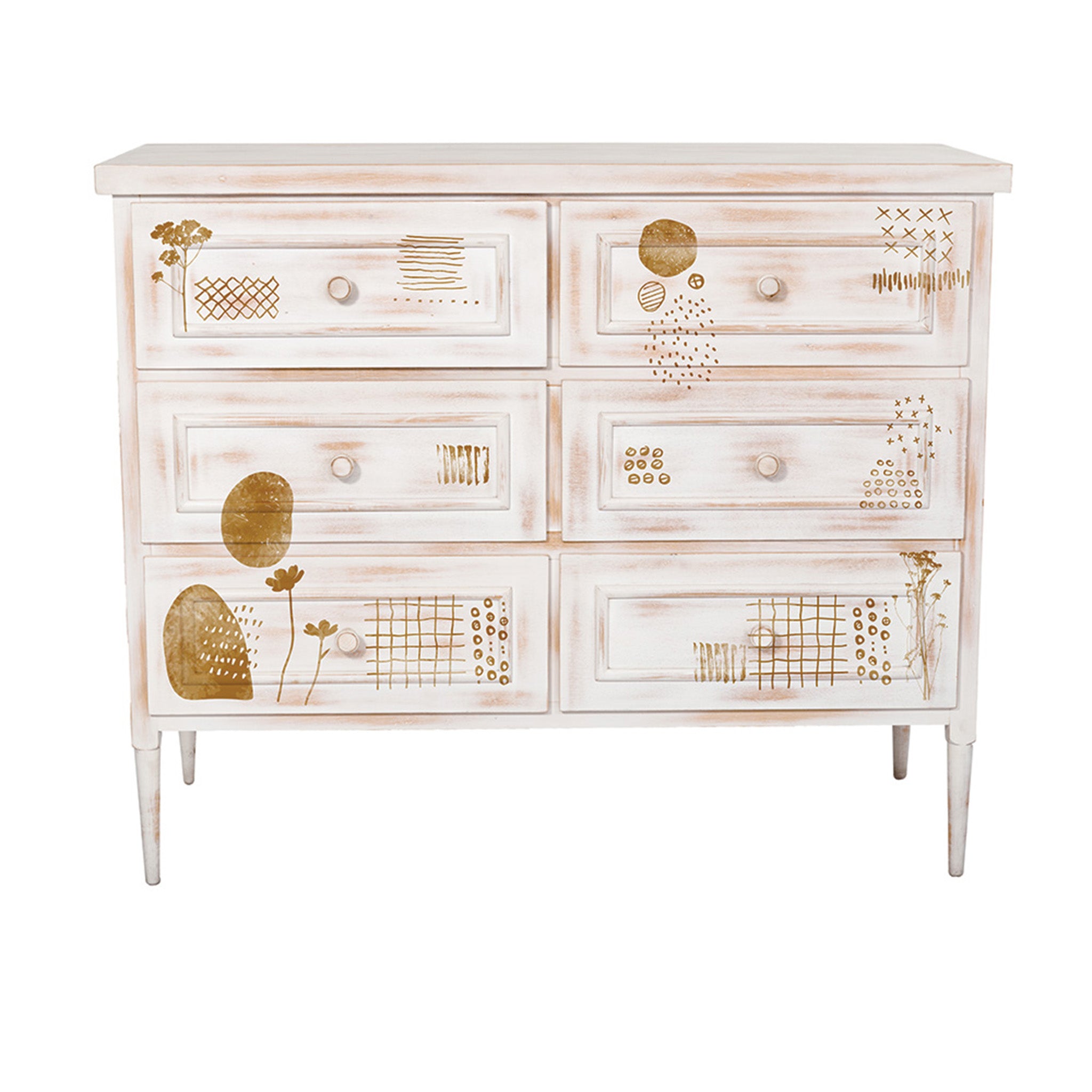 A 6-drawer dresser is painted distressed white and features ReDesign with Prima's Abstract Scribbles decor stamps in gold color on it. 