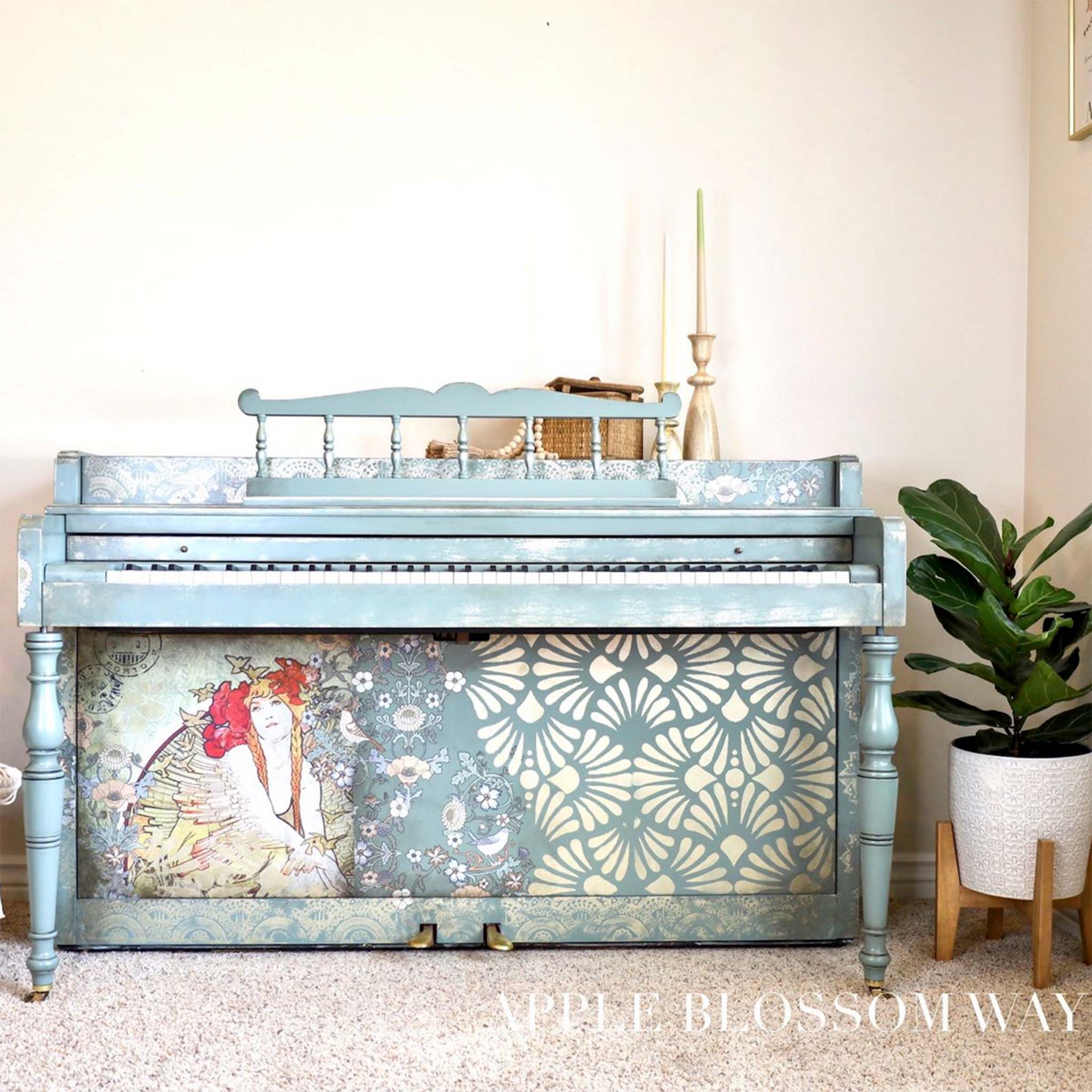 A vintage piano refurbished by Apple Blossom Way is painted pale blue and features ReDesign with Prima's Modern Deco stencil on the right half of the bottom front panel.