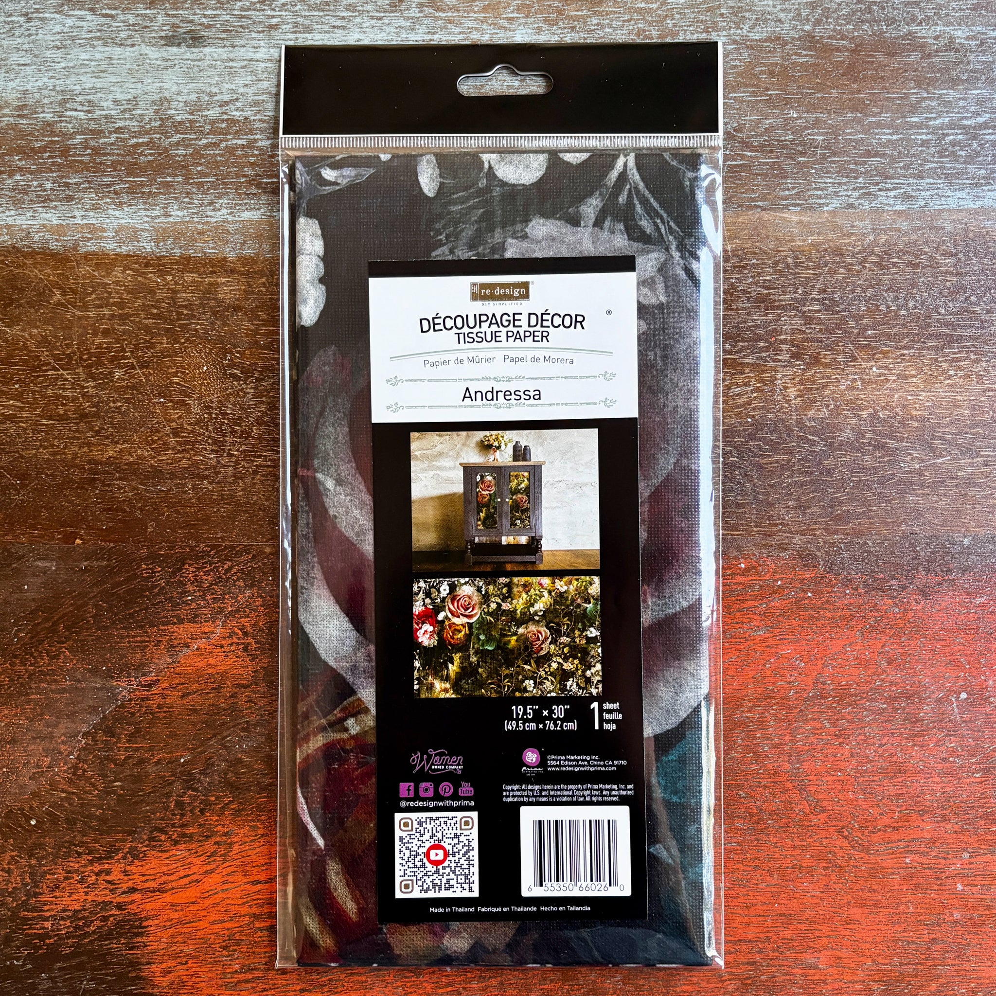 A package of ReDesign with Prima's Andressa tissue paper is against a dark wood background.