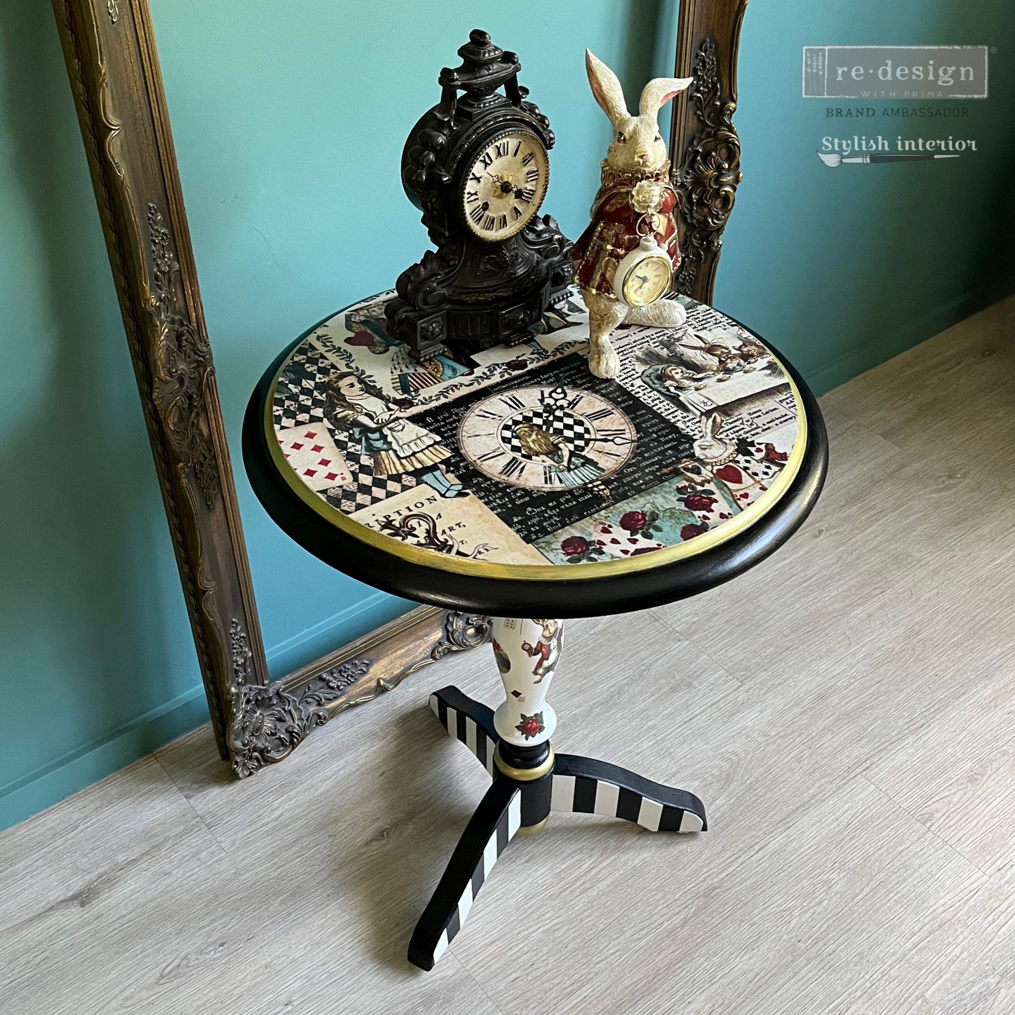 A vintage small side table refurbished by Stylish Interiors is painted black and white with gold accents and features ReDesign with Prima's Curious Journey tissue paper on the top and on the stand.