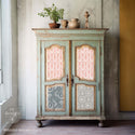 A vintage armoire is painted a pale green and features the Delicate Charm tissue papers on its doors.