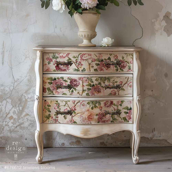 A vintage 3-drawer chest dresser is painted soft white and features ReDesign with Prima's KACHA Timeless Blooms fiber paper on the drawers.