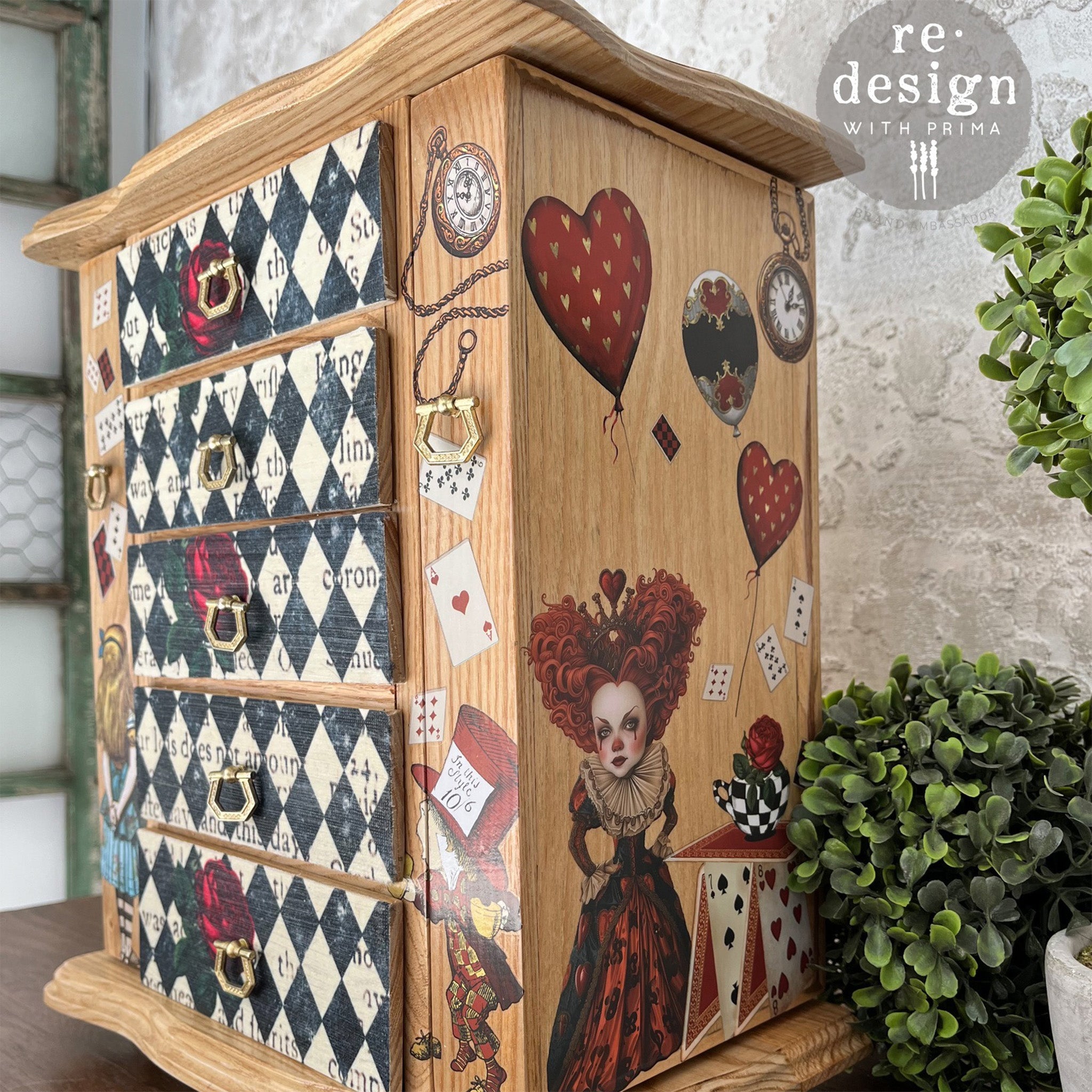 A small natural light wood table top jewelry armoire features ReDesign with Prima's Quees Court of Roses tissue paper on its 5 front drawers.