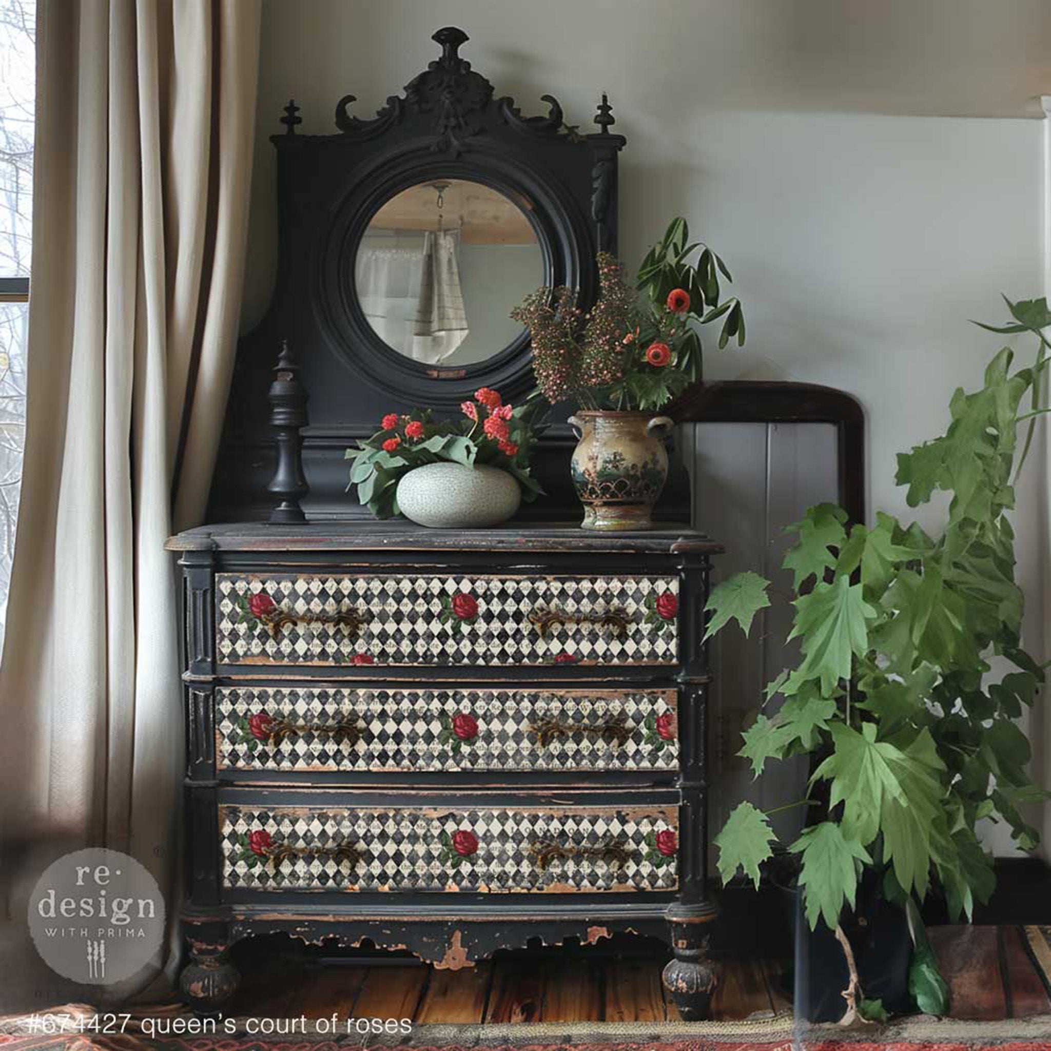 A vintage 3-drawer dresser with a mirror is painted black and features ReDesign with Prima's Queen's Court of Roses tissue paper on the drawers.