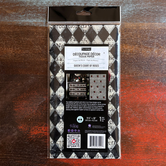 A package of ReDesign with Prima's Queen's Court of Roses tissue paper is against a dark wood background.