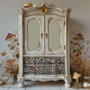 A vintage armoire is painted cream white and features ReDesign with Prima's Tea Party Whirlwind tissue paper on its 2 bottom drawers.