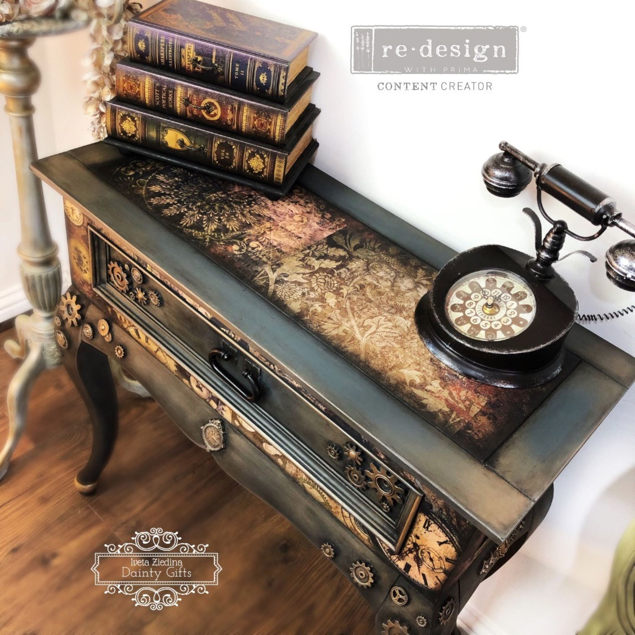 A vintage side table refurbished by Iveta Ziedina Dainty Gifts is painted in a steampunk style and features ReDesign with Prima's Gothic Rhapsody tissue paper on the top.