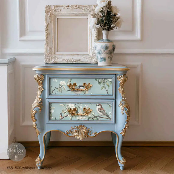 Furniture makeover mockup using Whispering Wings decoupage on blue dresser drawers with gold accents and bird-and-blossom design