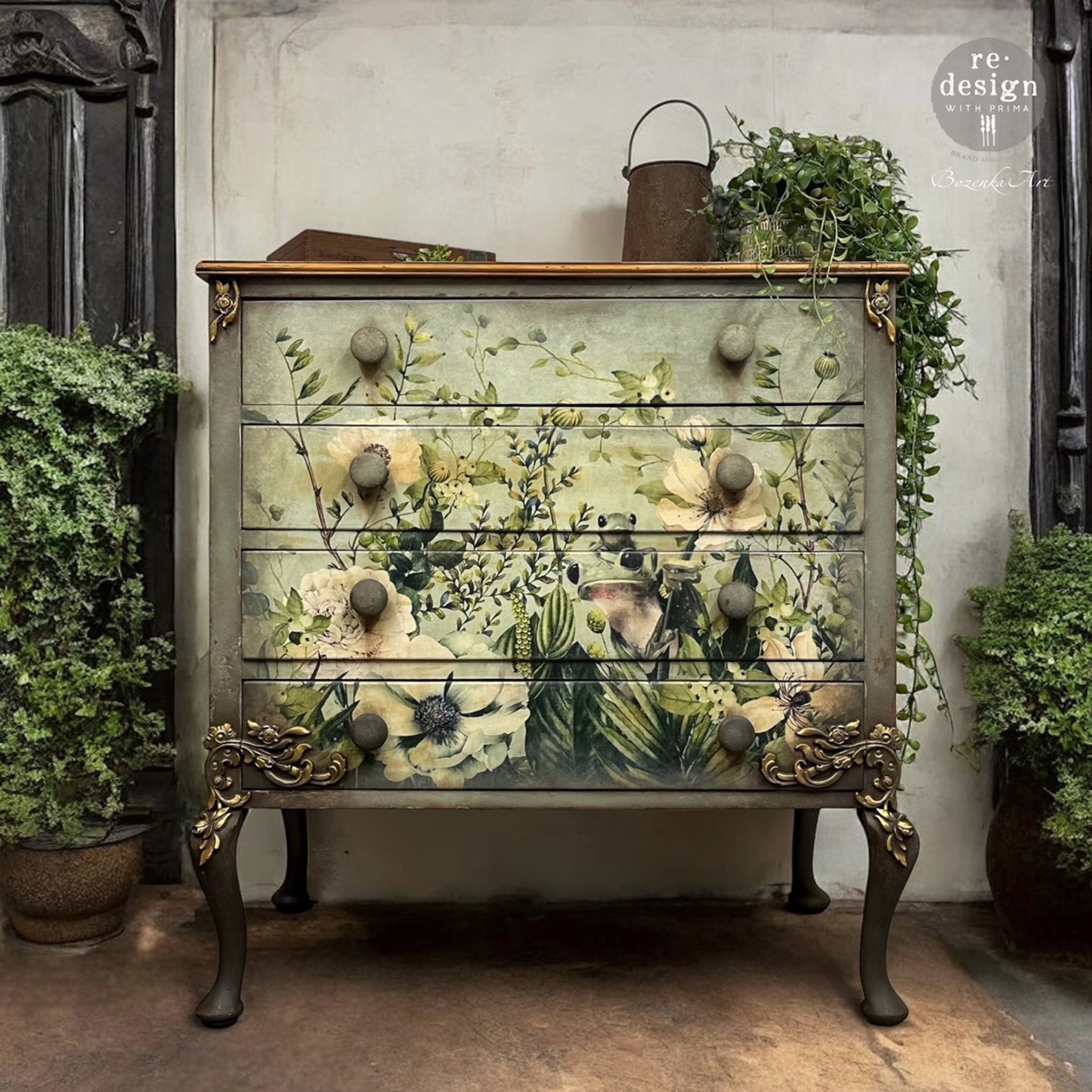 A vintage 4-drawer dresser refurbished by Bozenka Art is painted a gray-green and features ReDesign with Prima's Froggy Meadow Greens fiber paper on the front.