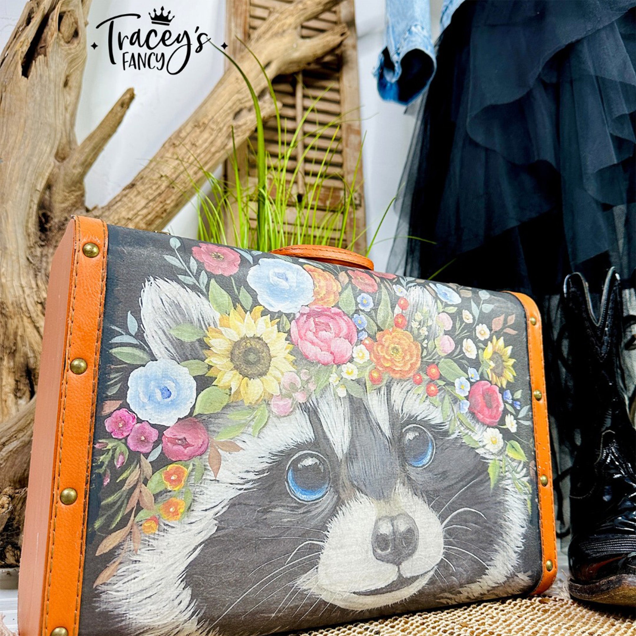 A vintage suitcase refurbished by Tracey's Fancy is painted coral pink and orange and features Belles & Whistles' Clever Raccoon rice decoupage paper on it.