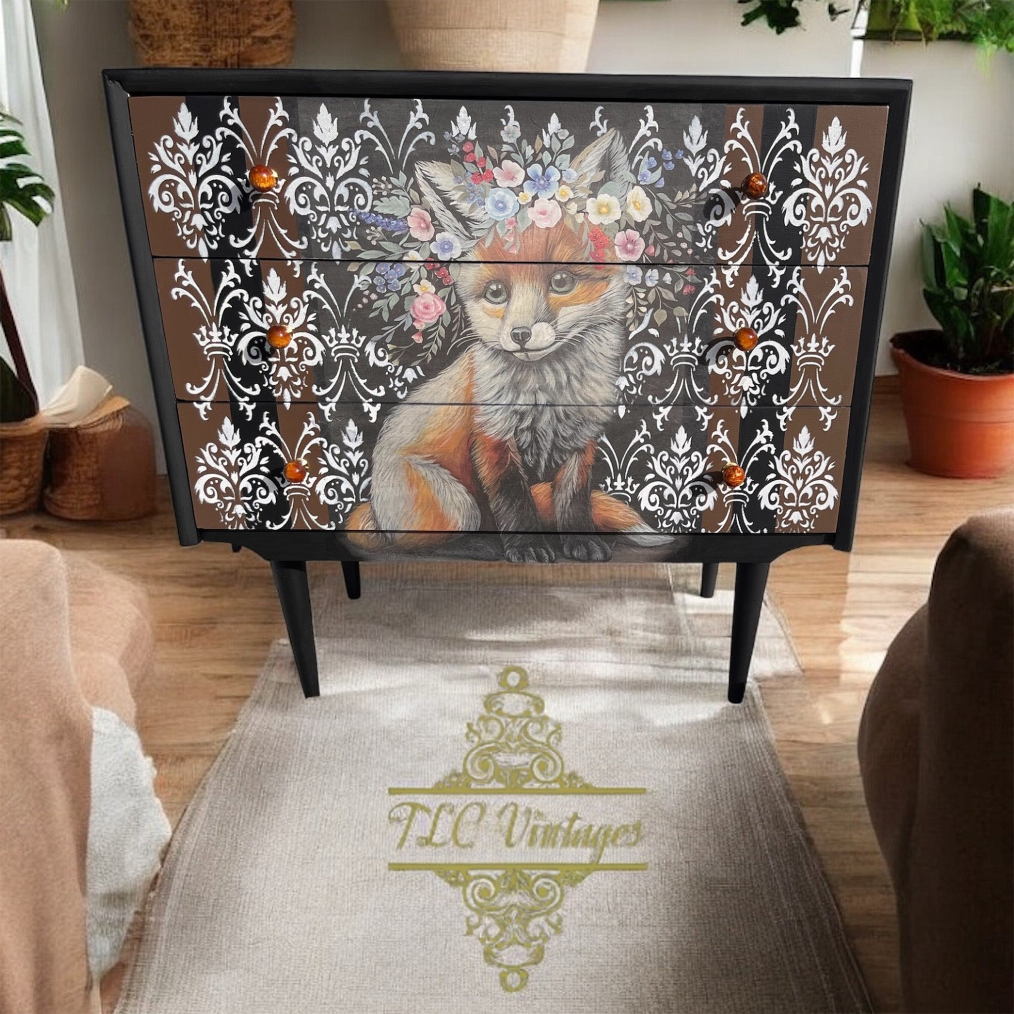 A 3-drawer dresser refurbished by TLC Vintages is painted black and features Belles & Whistles' Floraison Fox rice decoupage paper on the drawers.