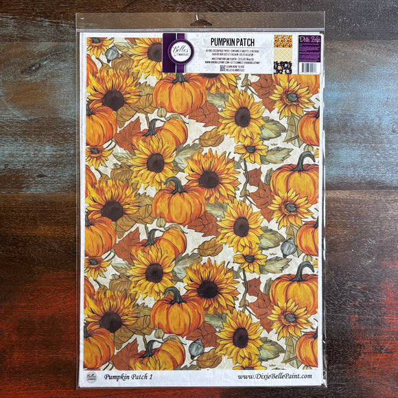 A package of Belles & Whistles' Pumpkin Patch A3 rice paper is against a dark wood background.