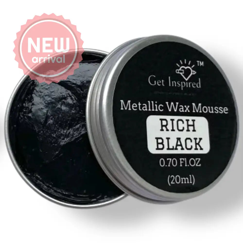 A 0.70 (20 ml) open container of a black metallic wax mousse paste is against a white background.