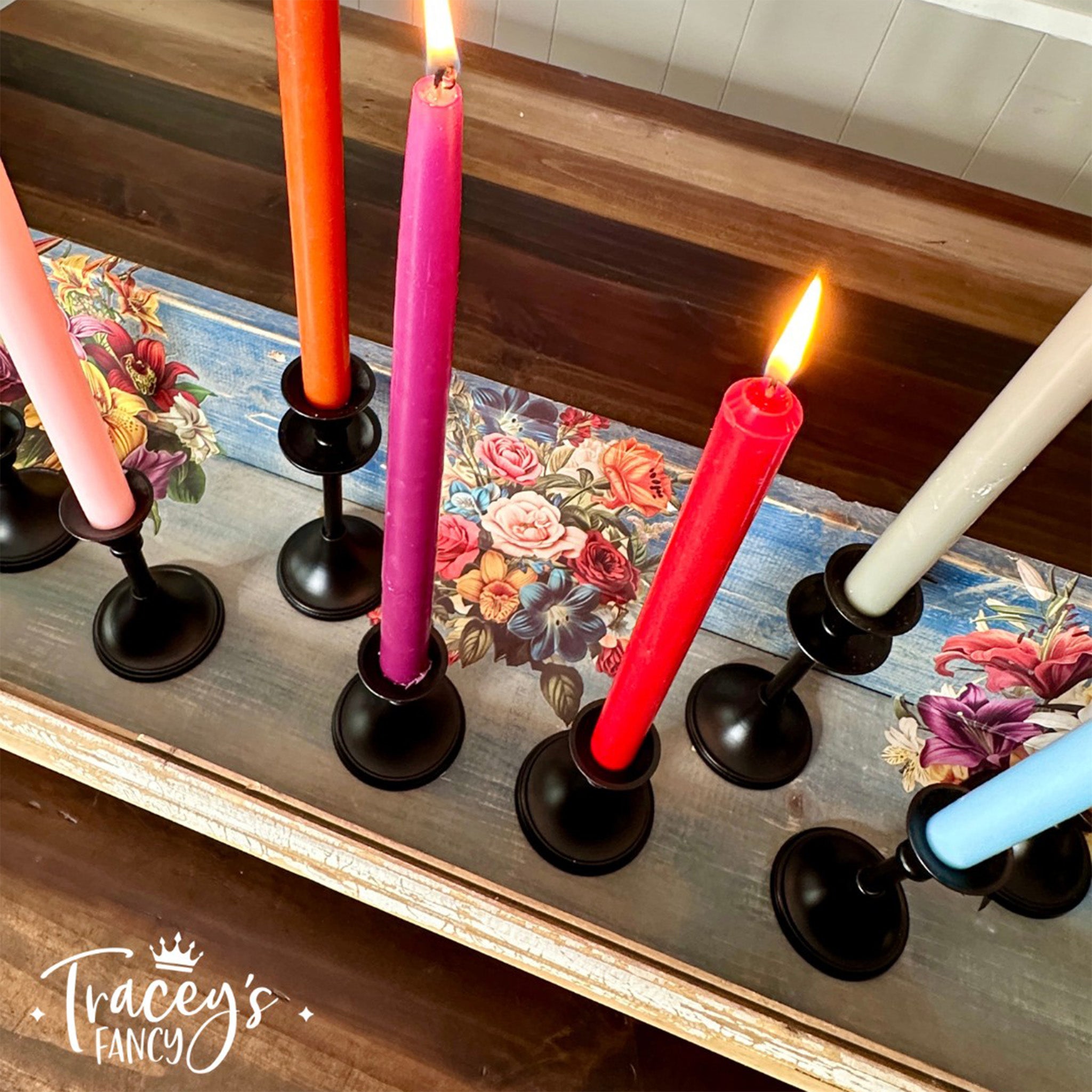 A wood plank created by Tracey's Fancy has candle sticks in holders on it and features Belles & Whistles' Antique Flora small rub-on transfer.