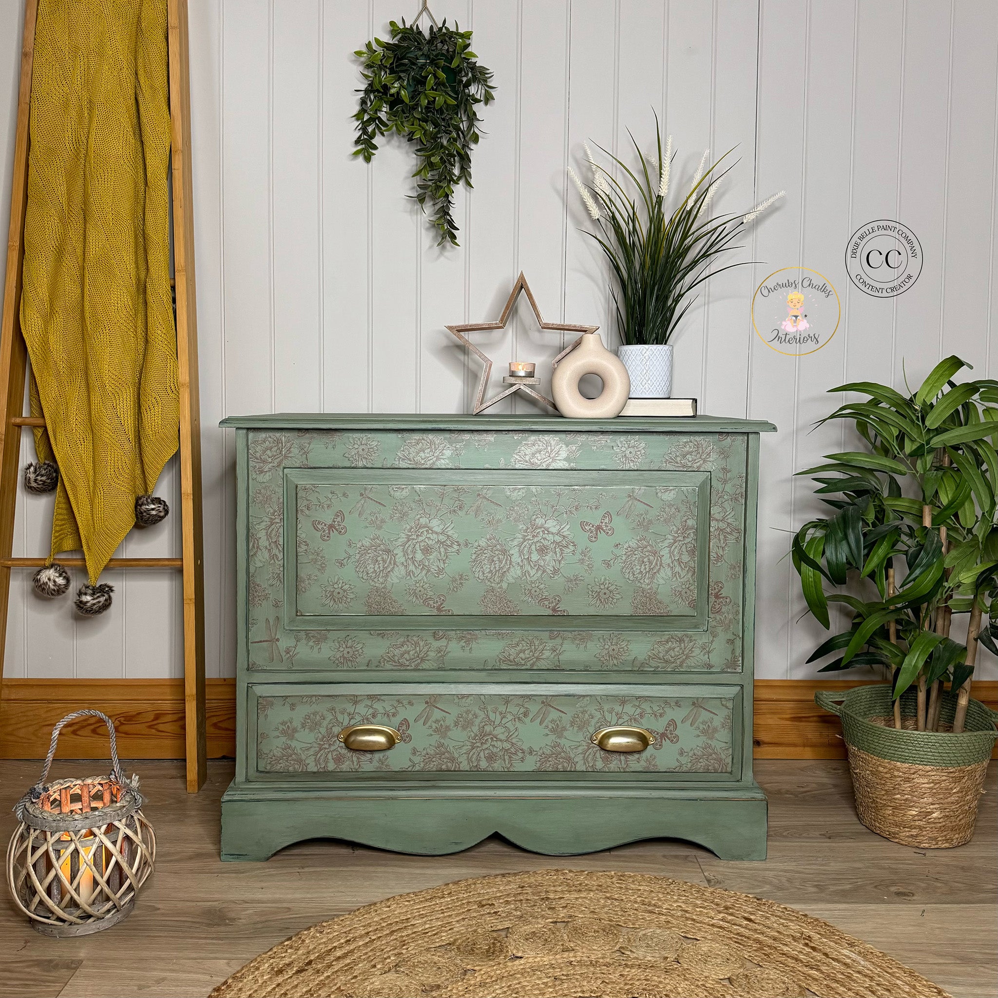 A vintage small buffet is painted light green and features Belles & Whistles' Dragonfly Blooms rub-on transfer on the front.