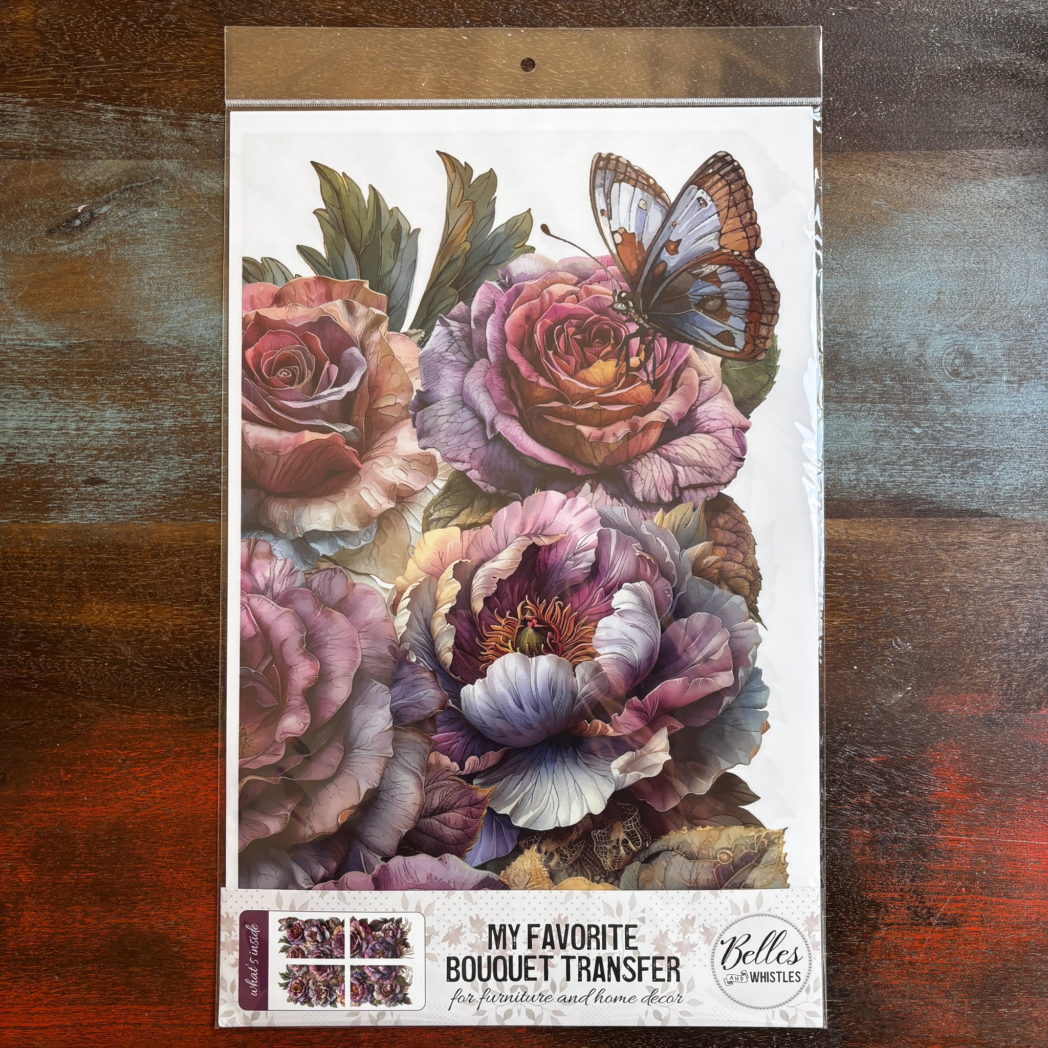 A package of Belles & Whistles' My Favorite Bouquet rub-on transfer is against a dark wood background.