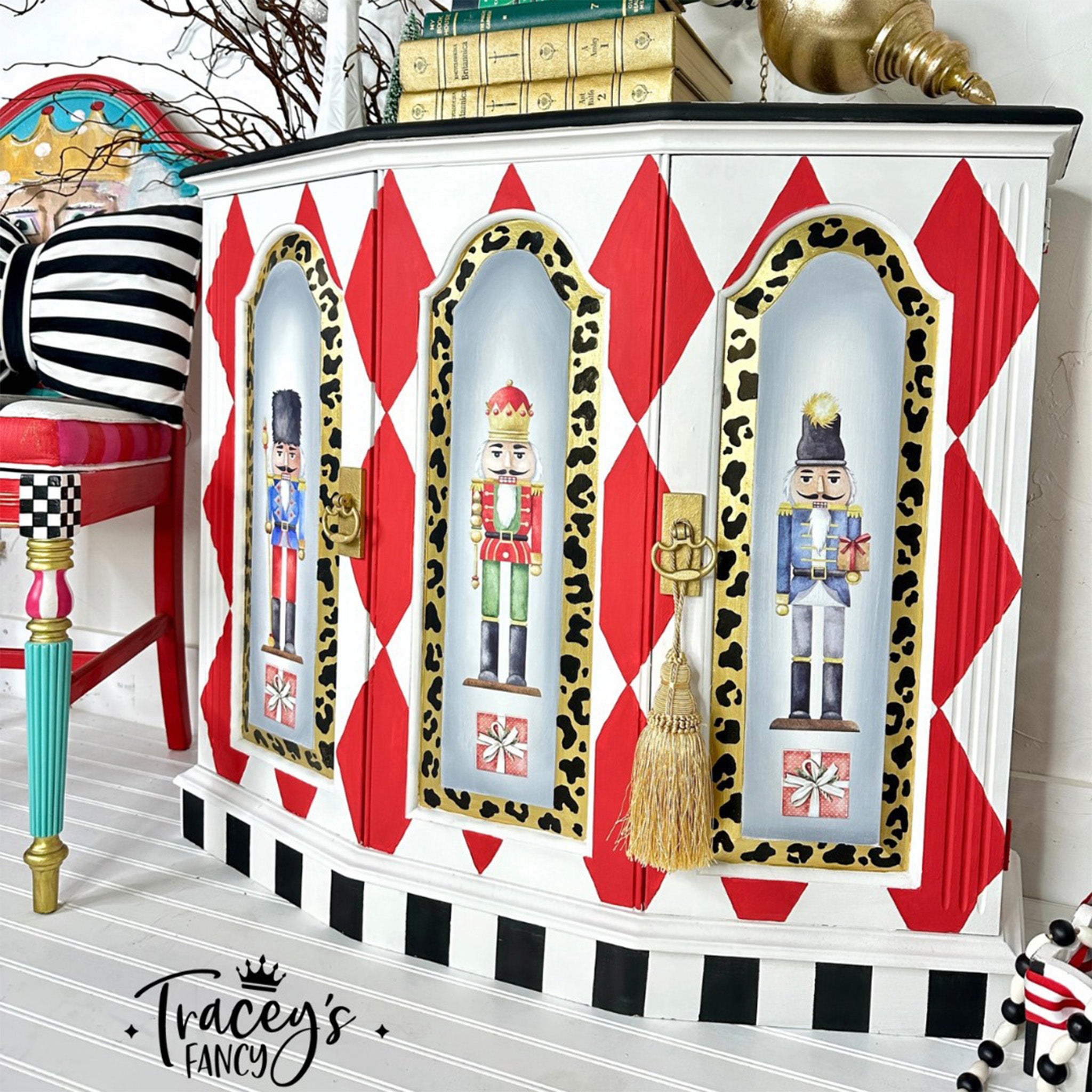 A small buffet cabinet refurbished by Tracey's Fancy is painted white with red harlequin diamonds and features Belles & Whistles' Nutcracker small rub-on transfer on its doors.