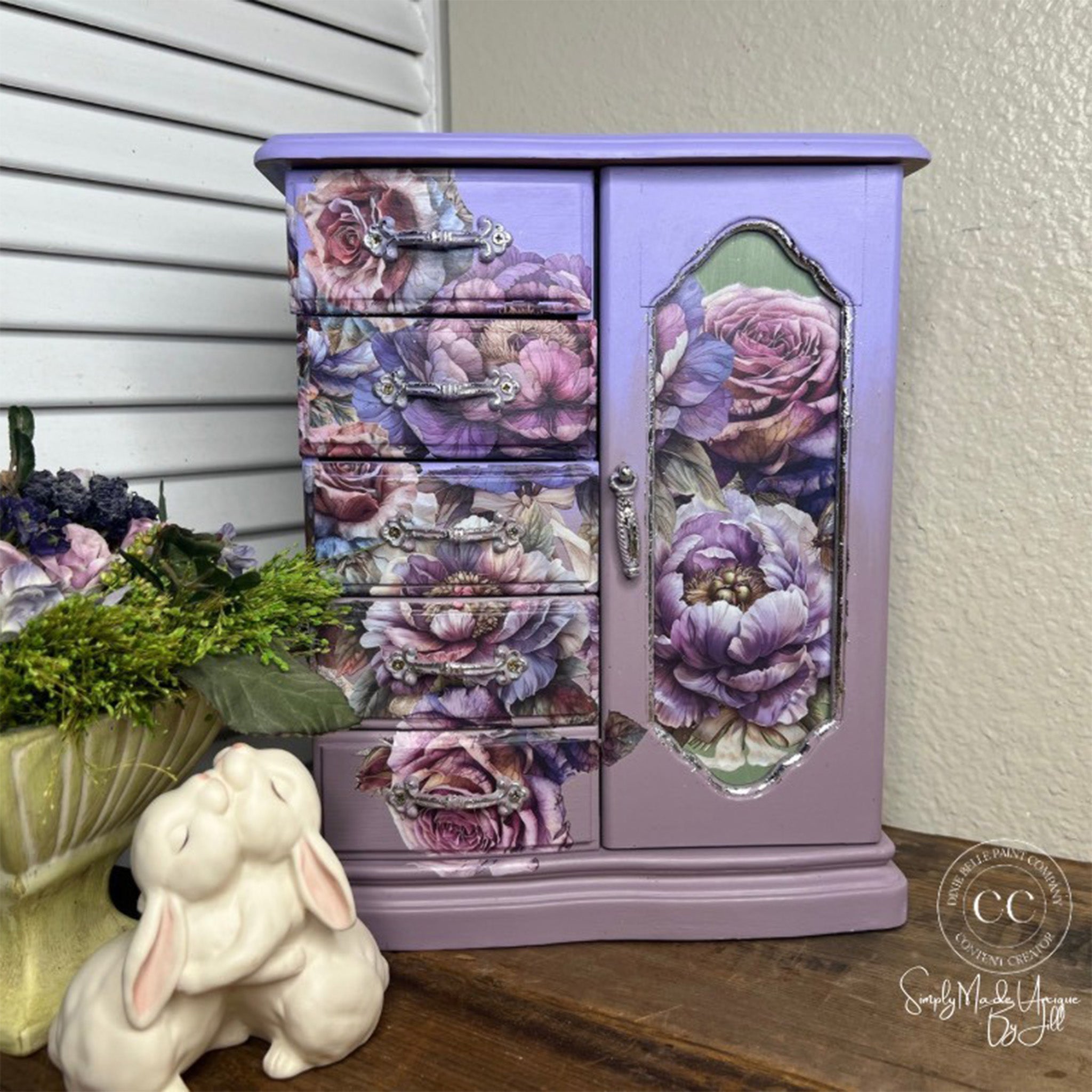 A standing table top jewelry box is painted iridescent purple and features Belles & Whistles' Roses and Peonies small rub-on transfer on it.