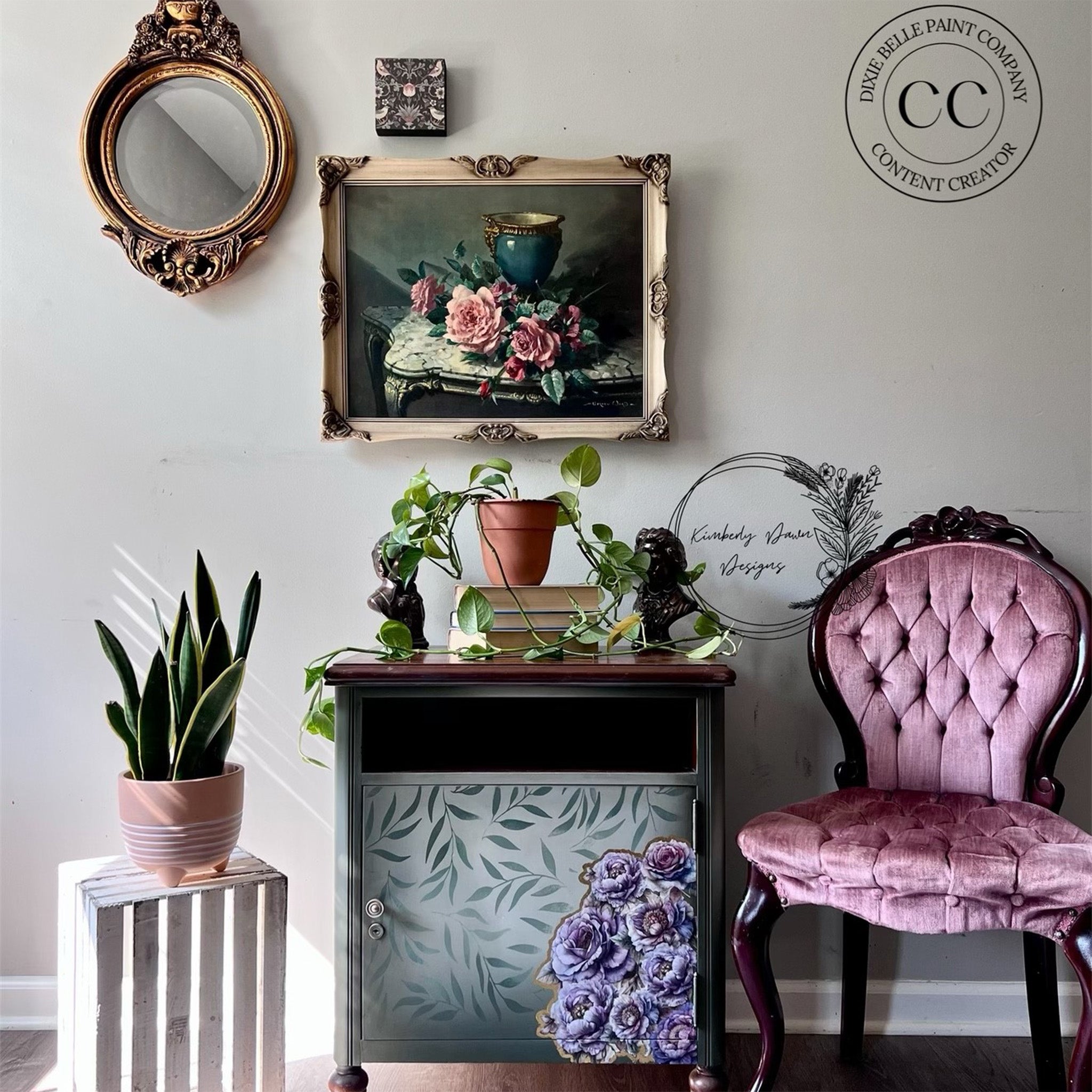 A nightstand with a cubby hole and door under it for storage is painted grey with leaves and features Belles & Whistles' Roses and Peonies small rub-on transfer on the bottom right corner of the door.