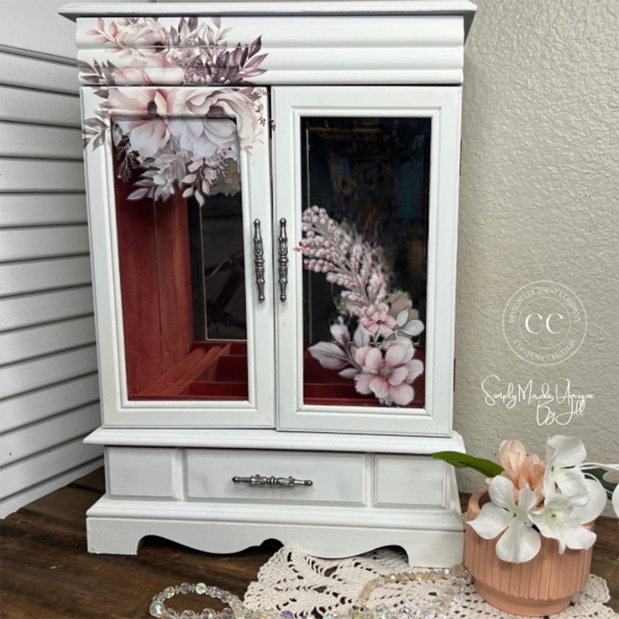 A table-top jewelry box is painted white and features Belles & Whistles' Soft Wintery Floral rub-on transfer on it.