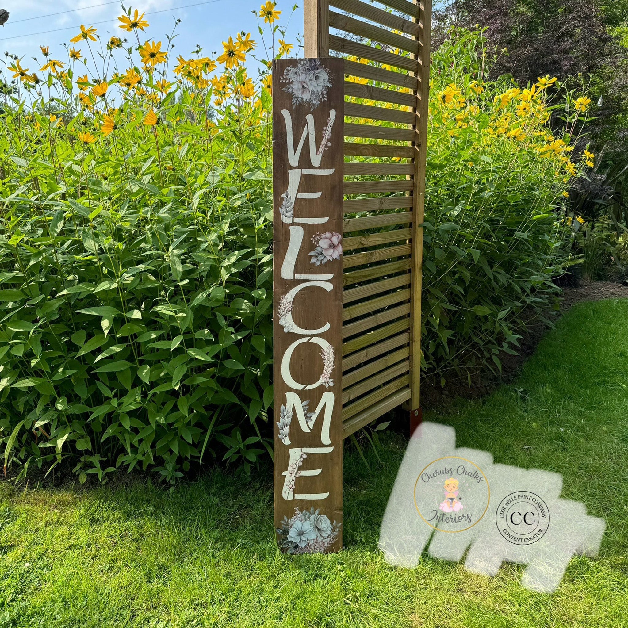 A tall wood Welcome sign created by Cherub's Chalks Interiors features Belles & Whistles' Tea Party Bouquet small rub-on transfer on it.