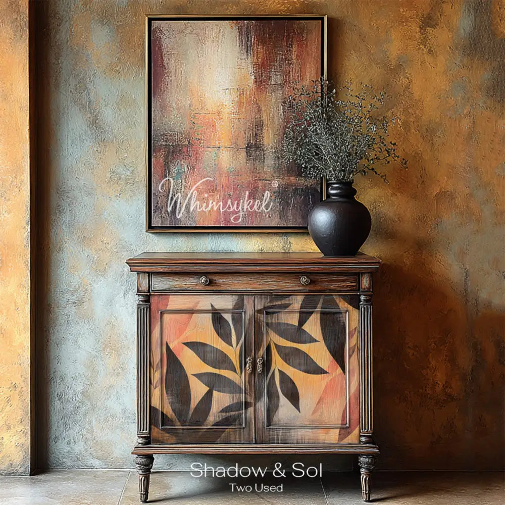 A vintage small buffet cabinet has natural wood and features Whiimsykel's Shadow and Sol tissue paper on its 2 doors.