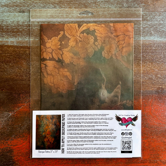 A package of Whimsykel's Baroque Patina tissue paper is against a dark wood background.