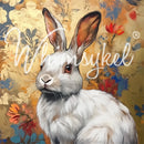 Close-up of a tissue paper featuring a white rabbit set against a floral brocade background in gold and blue hues. 