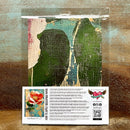 A package of Whimsykel's Coral Blossom tissue paper is against a wood background.