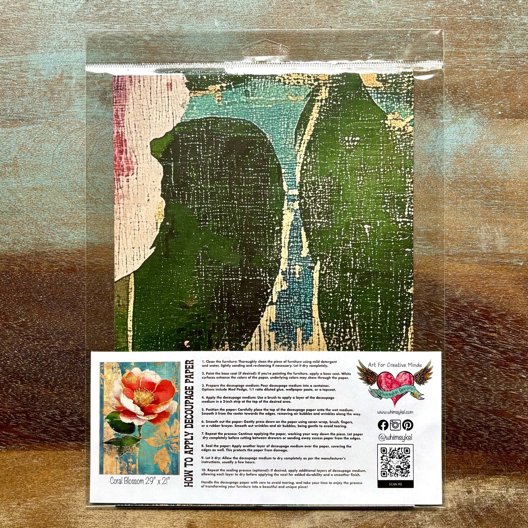 A package of Whimsykel's Coral Blossom tissue paper is against a wood background.