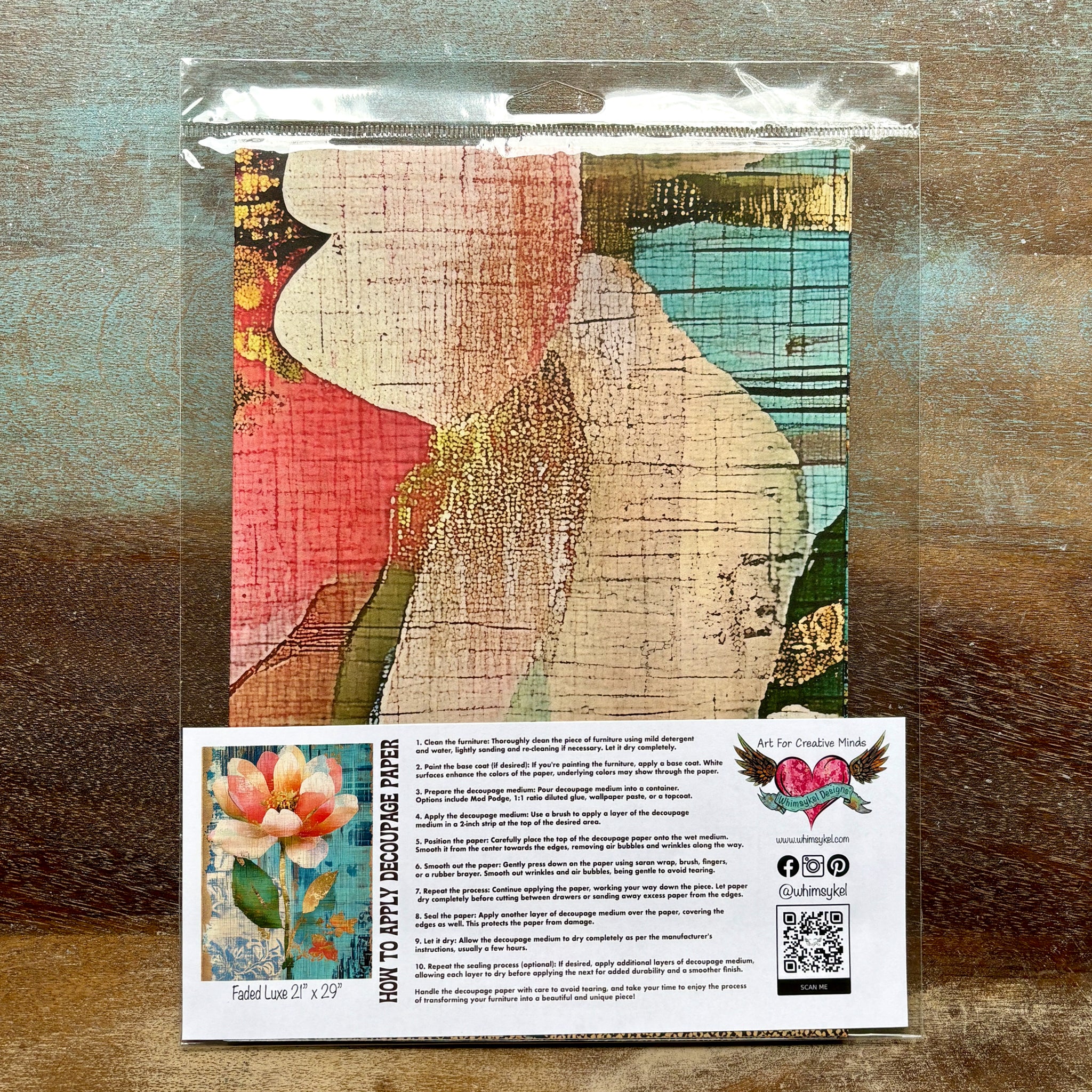 A package of Whimsykel's Faded Luxe tissue paper is against a wood background.