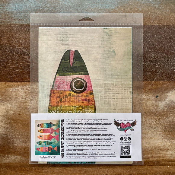 A package of Whimsykel's Fish Fables tissue paper is against a wood background.