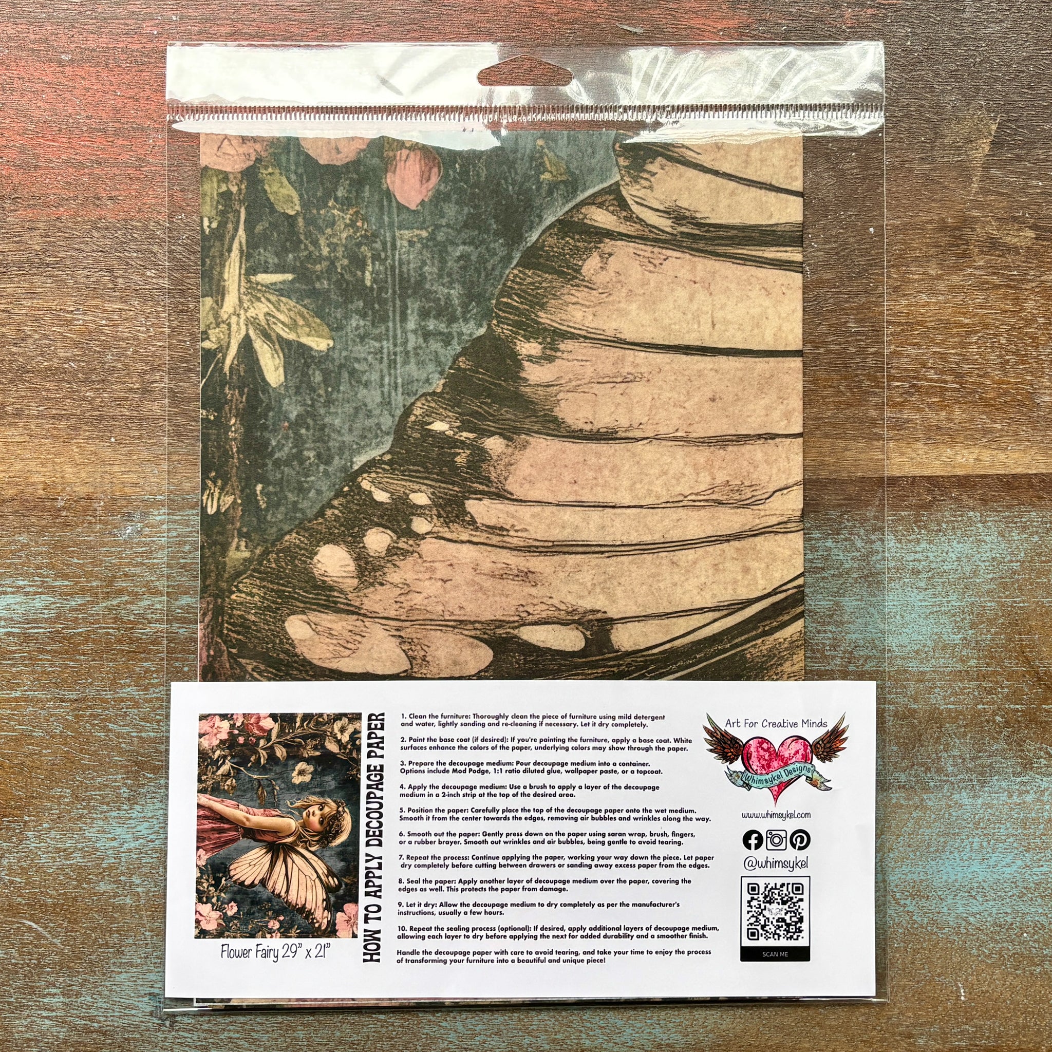 A package of Whimsykel's Flower Fairy tissue paper is against a wood background.