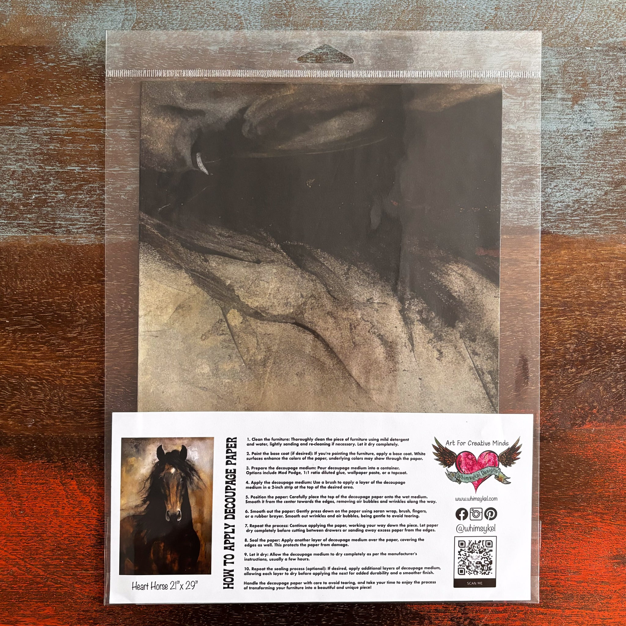 A package of Whimsykel's Heart Horse tissue paper is against a dark wood background.