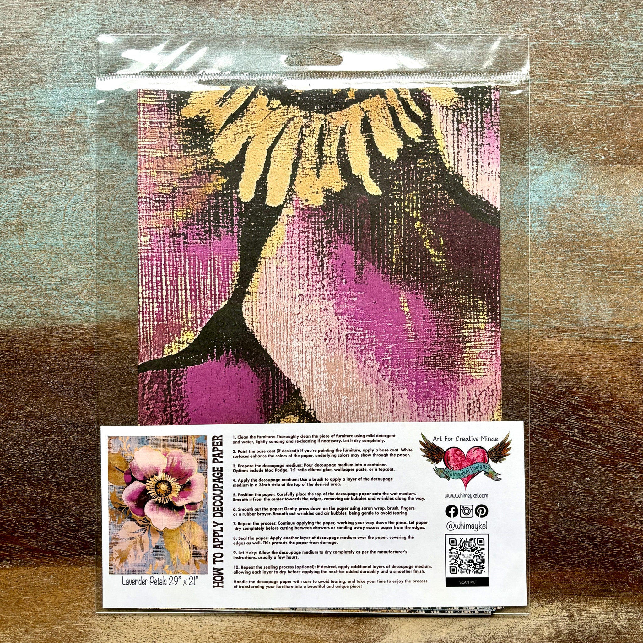 A package of Whimsykel's Lavender Petals tissue paper is against a wood background.