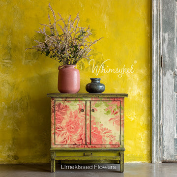 A vintage small buffet cabinet has weathered olive green paint and features Whimsykel's Limekissed Flowers tissue paper on the front.