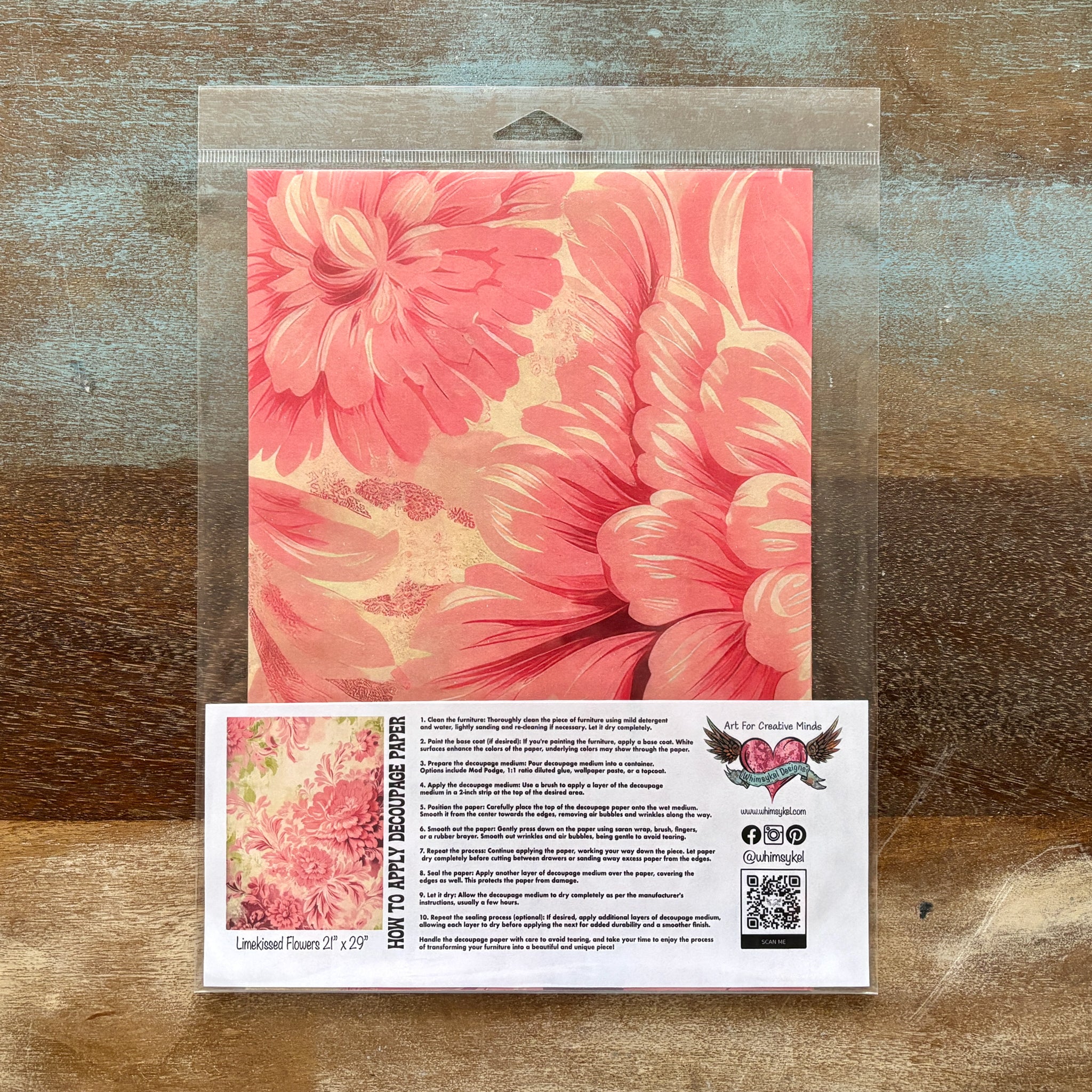 A package of Whimsykel's Limekissed Flowers tissue paper is against a wood background.