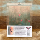A package of Whimsykel's Meadowglow tissue paper is against a wood background.