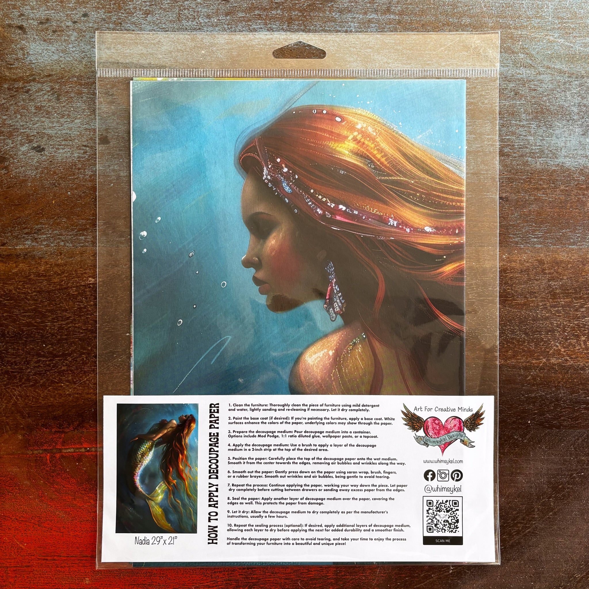 A package of Whimsykel's Nadia tissue paper is against a dark wood background.