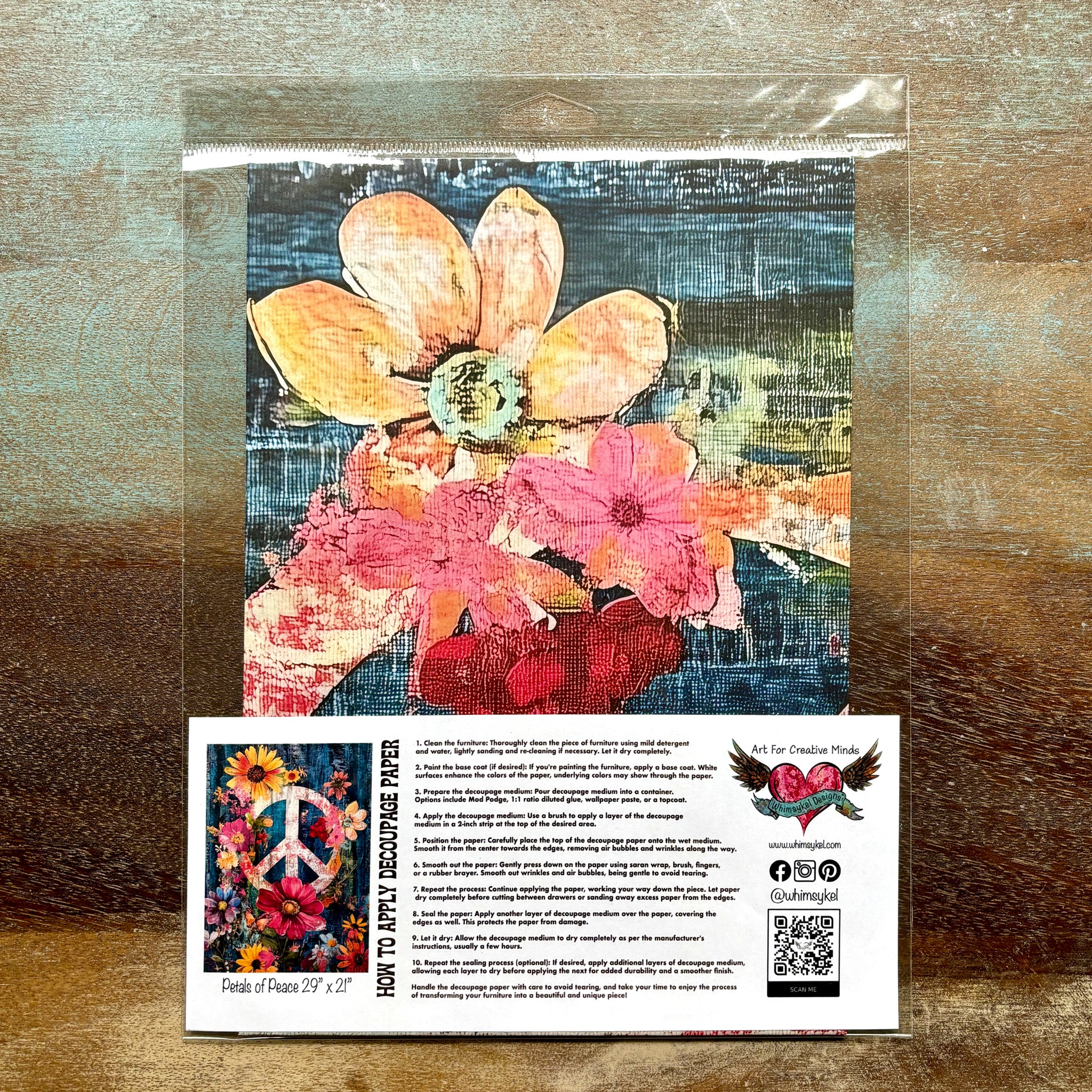 A package of Whimsykel's Petals of Peace tissue paper is against a wood background.