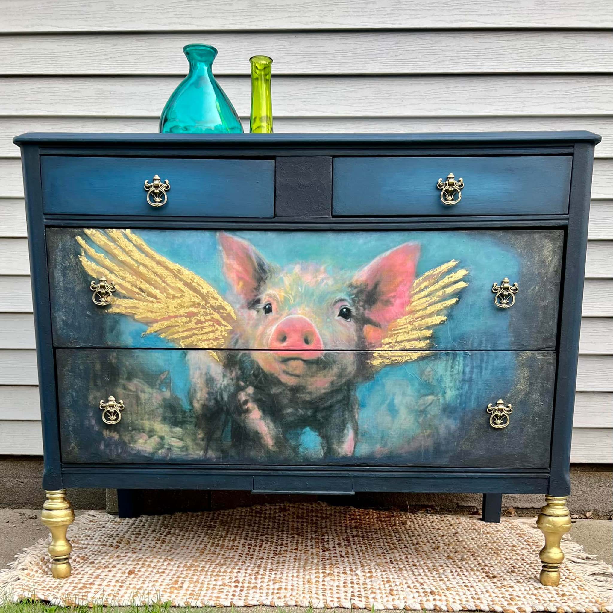 A vintage dresser with 2 small top drawers and 2 large bottom drawers features Whimsykel's Pigasus tissue paper covering the 2 large drawers.