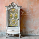 A vintage glass-faced armoire is painted white and features Whimsykel's Romantic Fleurs tissue paper on its backboard.