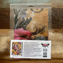 Packaged product with decorative paper and instructions on a wooden surface