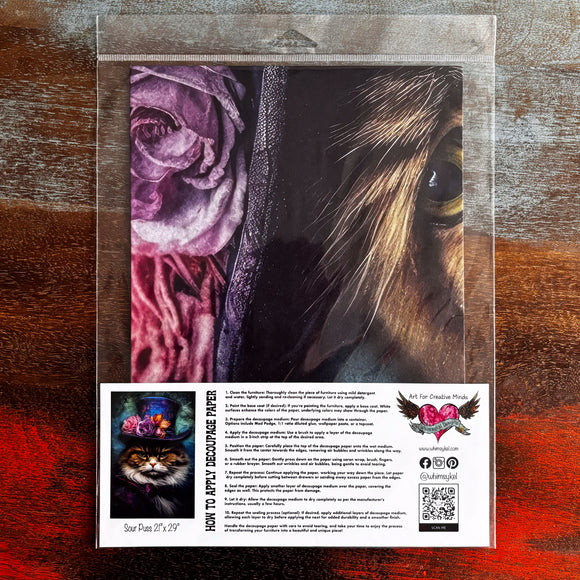 A package of Whimsykel's Sour Puss tissue paper is against a dark wood background.