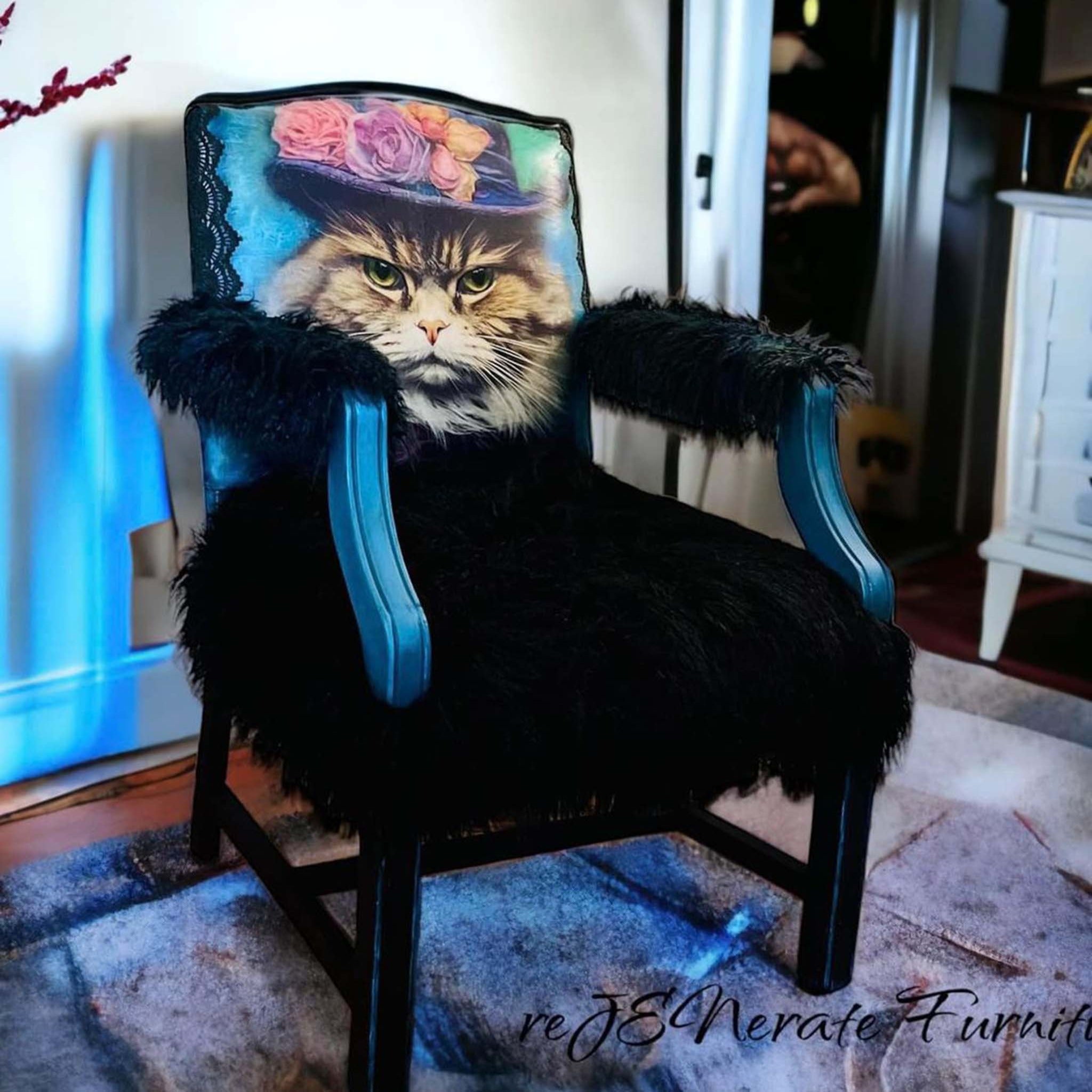 A vintage arm chair refurbished by reJENerate Furniture is painted blue and black with fuax shag fur on the seat and arms and features Whimsykel's Sour Puss tissue paper on the front of the back seat.