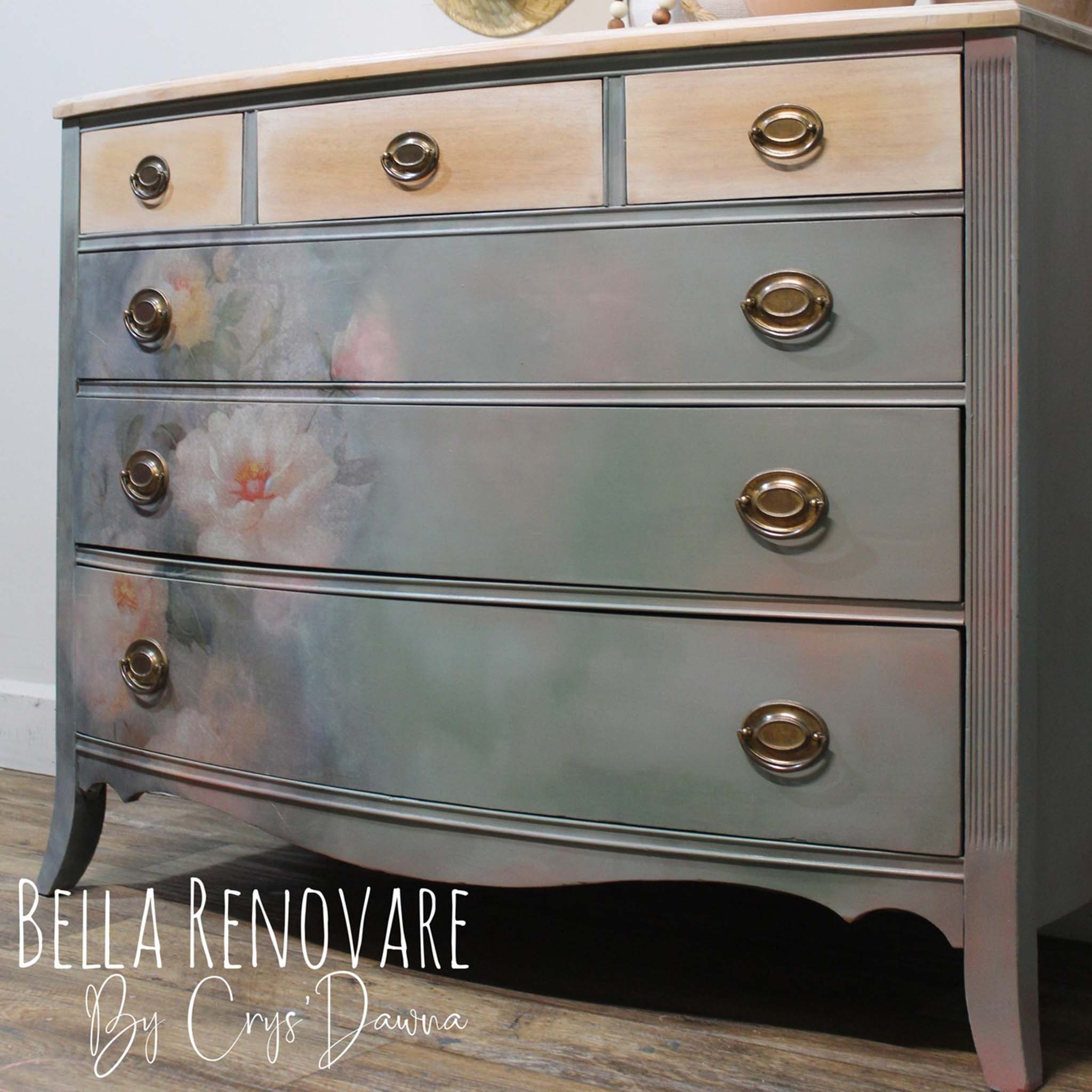 A vintage 6-drawer dresser refurbished by Bella Renovare by Crys'Dawna is painted a blend of very light grey and pink and features Whimsykel's Weathered Roses tissue paper on its 3 large bottom drawers.