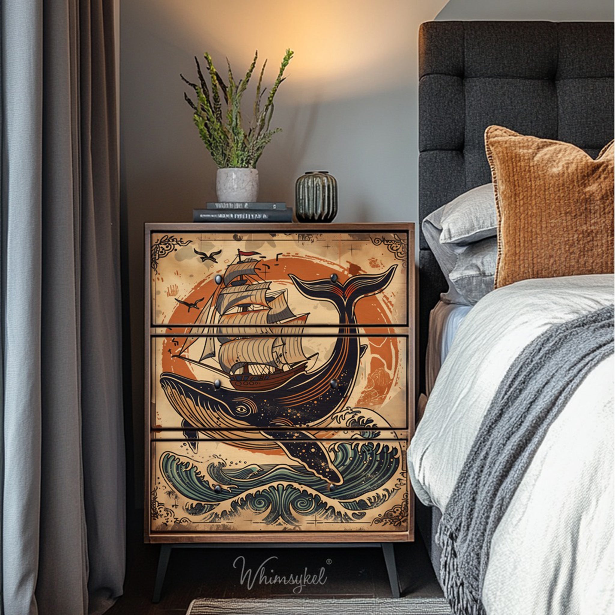 A 3-drawer dresser next to a bed features Whimsykel's Whale of a Tale tissue paper on the front.