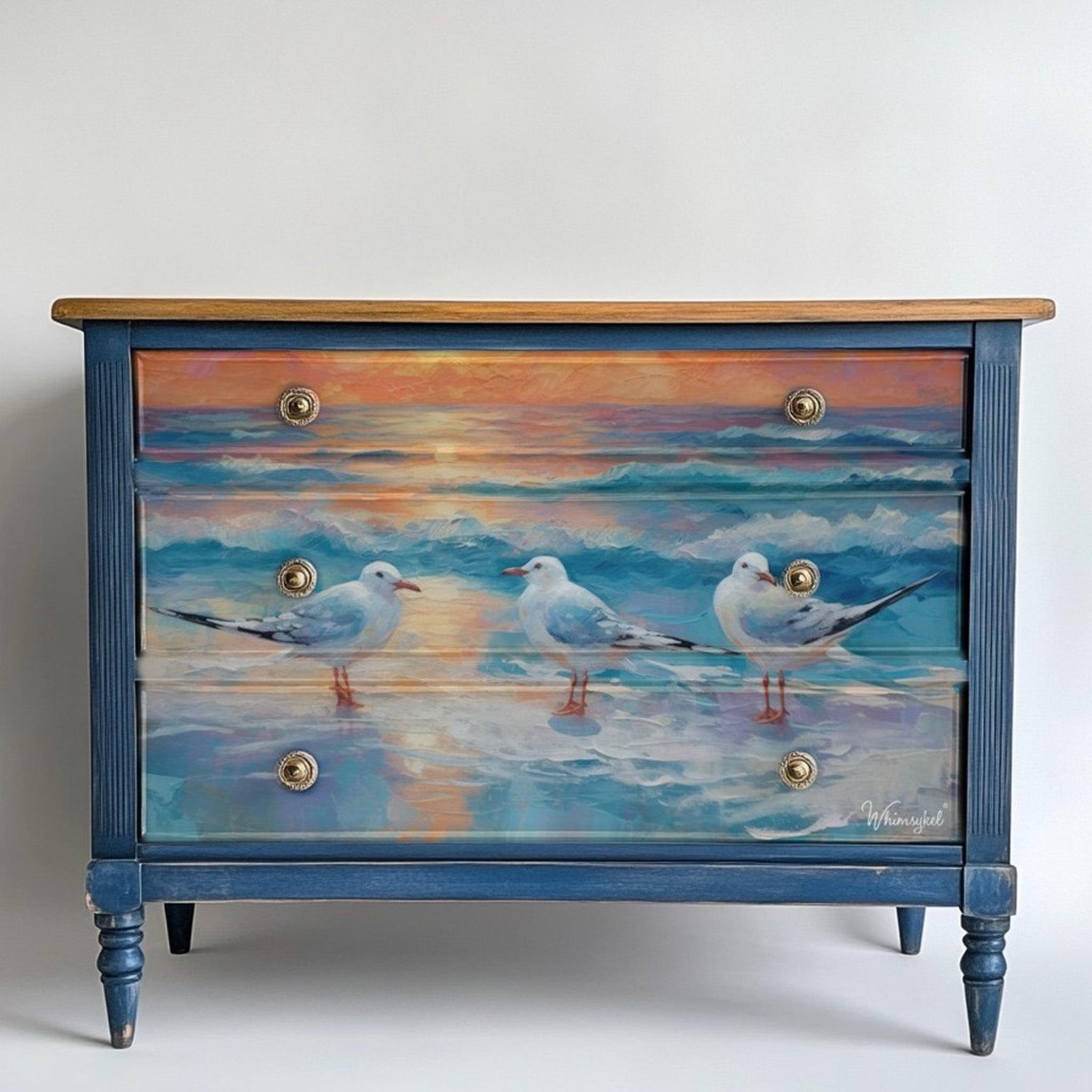 A vintage 3-drawer dresser is painted blue and features Whimsykel's Morning Chatter tissue paper on the drawers.